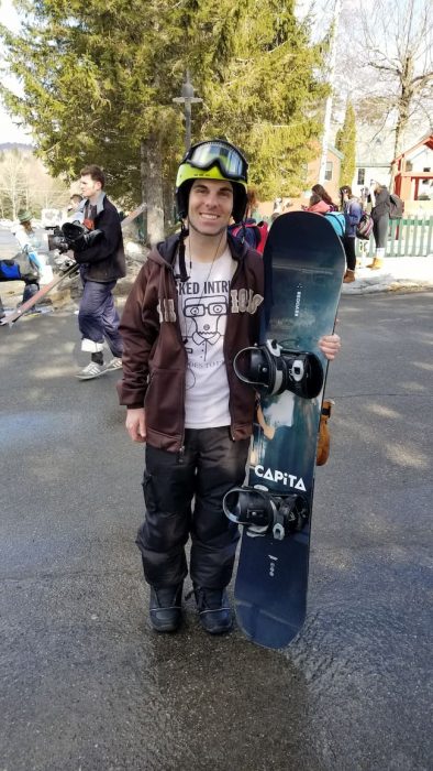 Steve holding the 2019 - 2020 Capita DOA