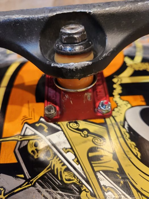 Independent Titanium Trucks with orange indy bushings