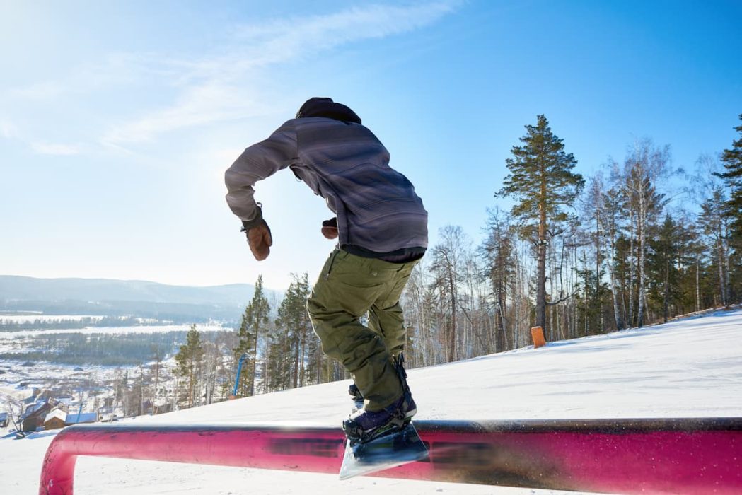 a snowboarder jibbing a rail