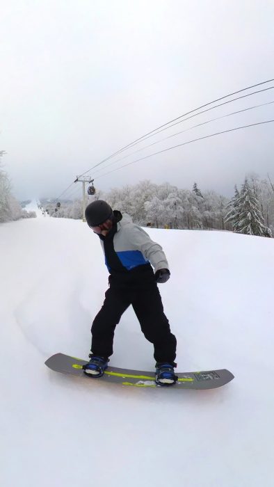 Steve making a heelside carve on a Ride Warpig snowboard