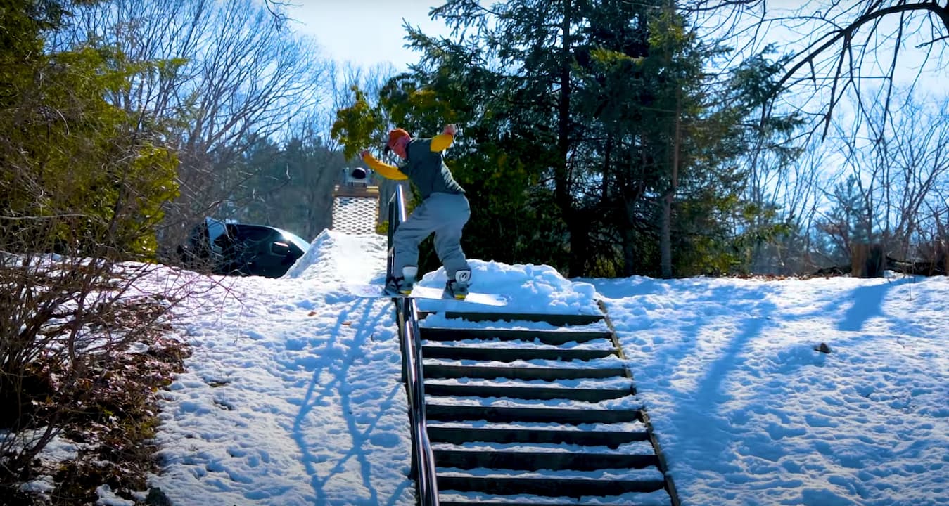 Snowboarder Joe McEvoy front boarding a hand rail