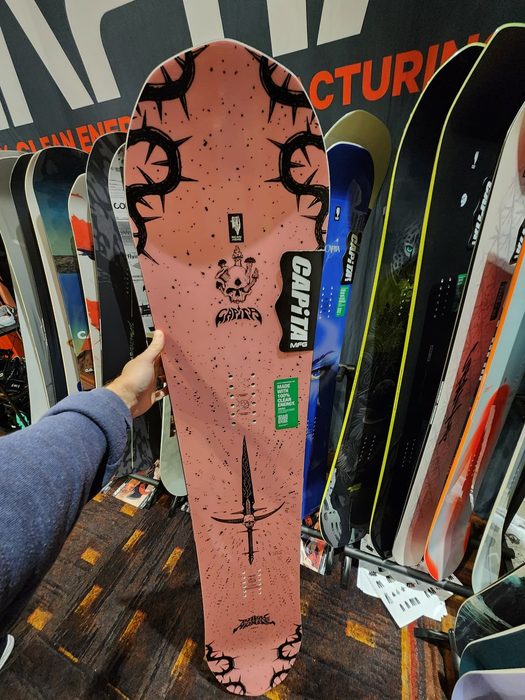 Holding the new 2027 Capita Dark Horse to show its new top sheet
