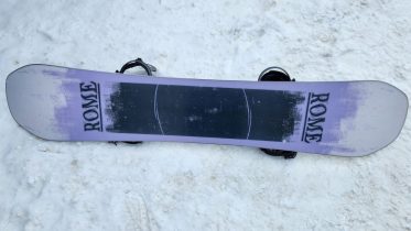 Rome Boneless 2026-2027 snowboard resting on snow with its base pointed up