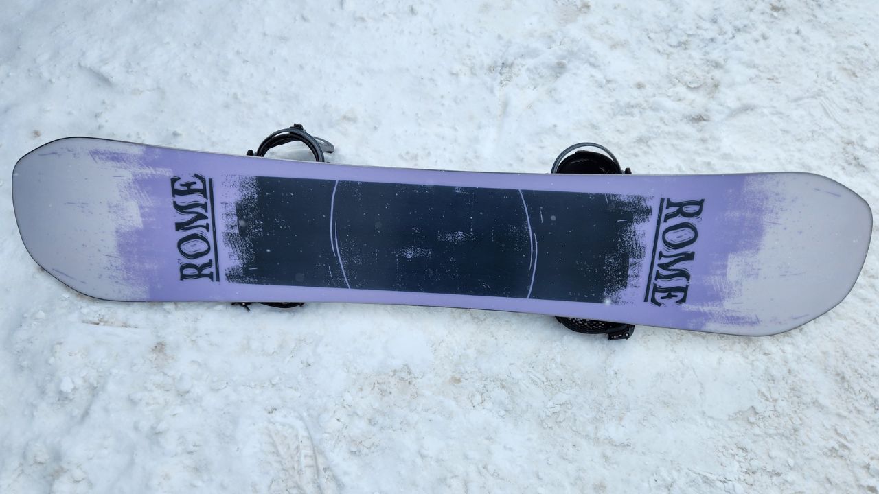 Rome Boneless 2026-2027 snowboard resting on snow with its base pointed up
